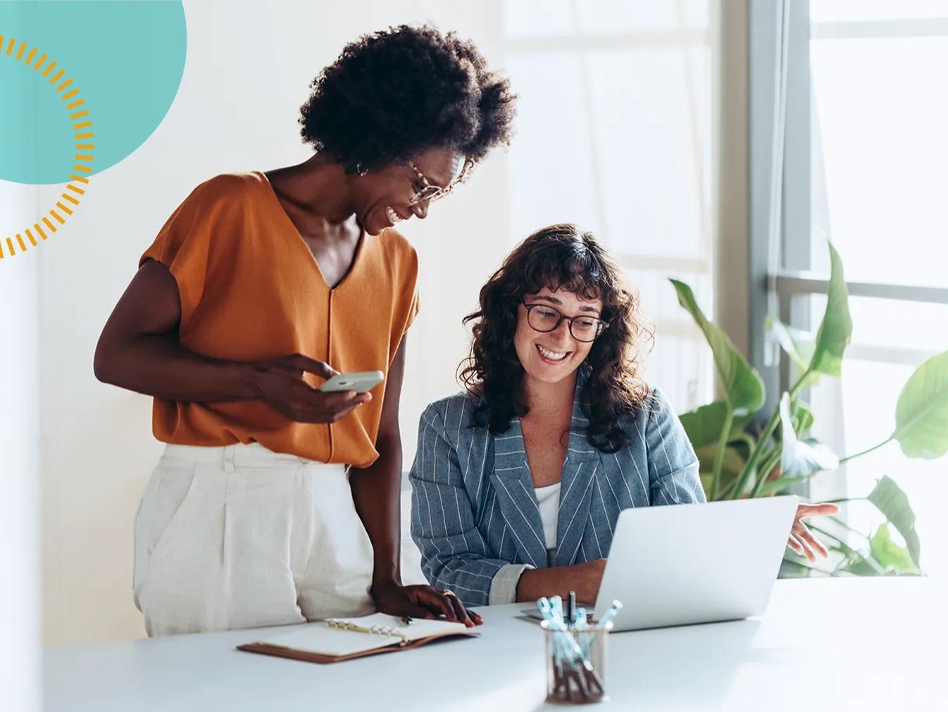 two women looking at a project on a laptop computer