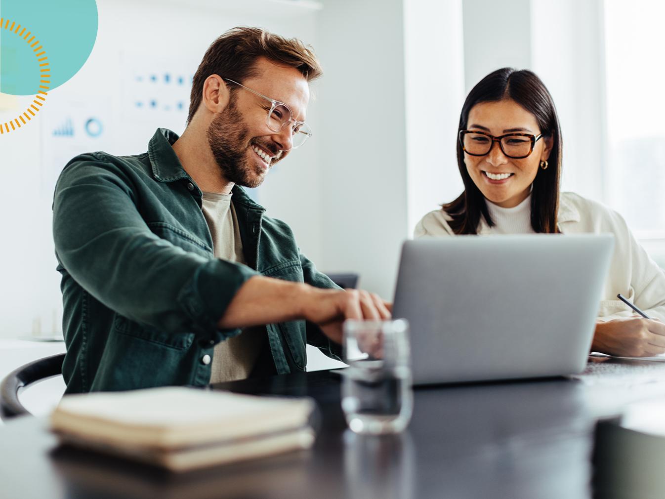 man and woman collaborating on a laptop