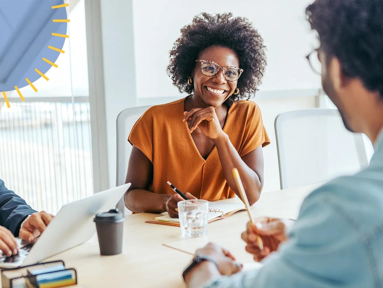 woman smiling in a team meeting