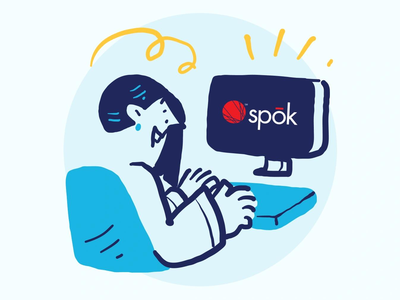 woman working on a desktop computer showing the Spok logo
