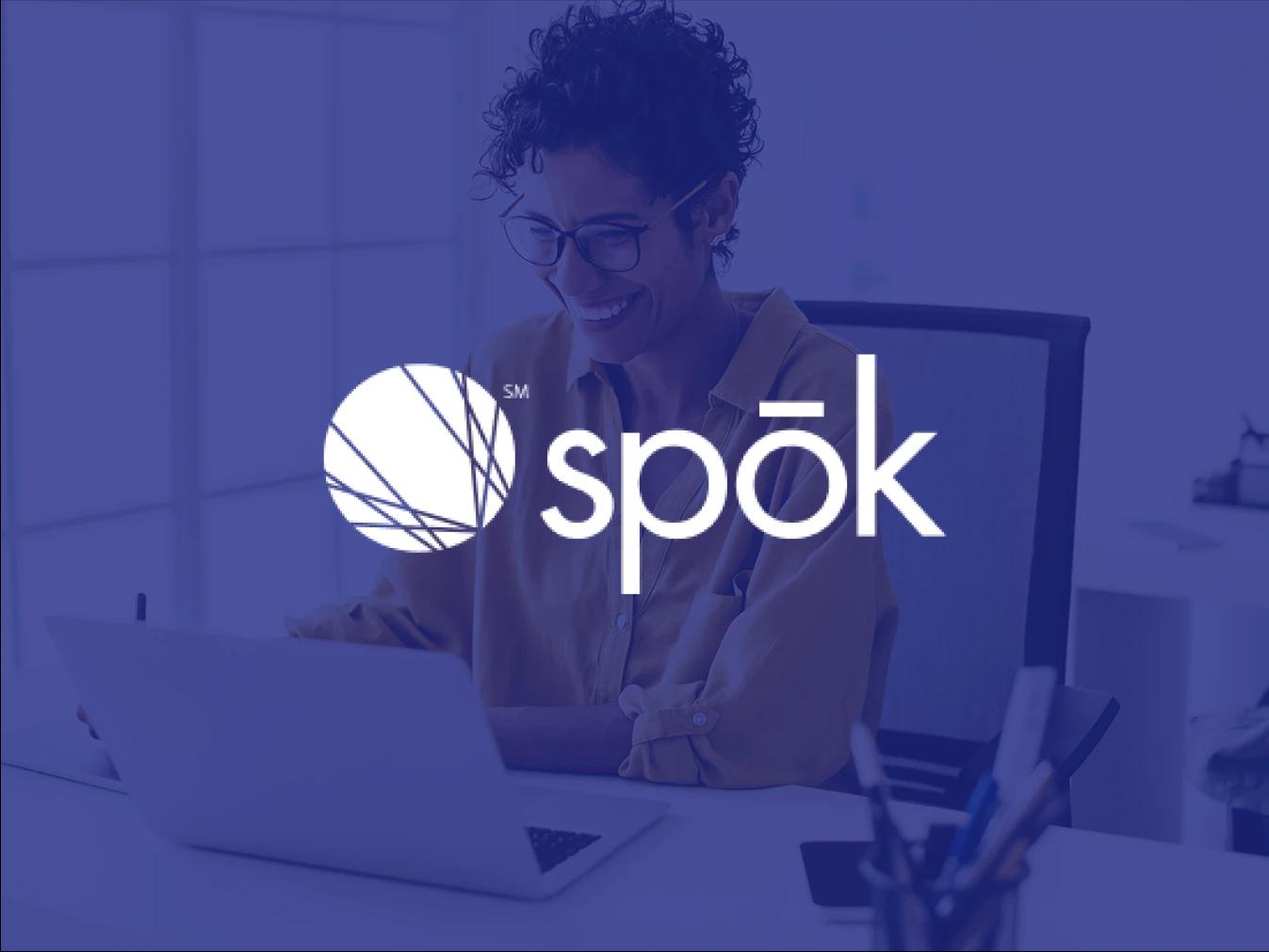 image of woman working on a laptop computer overlayed with the Spok logo